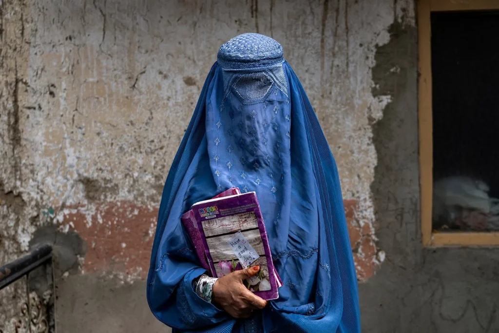 afghan woman with books ap photo: ebrahim noroozi)